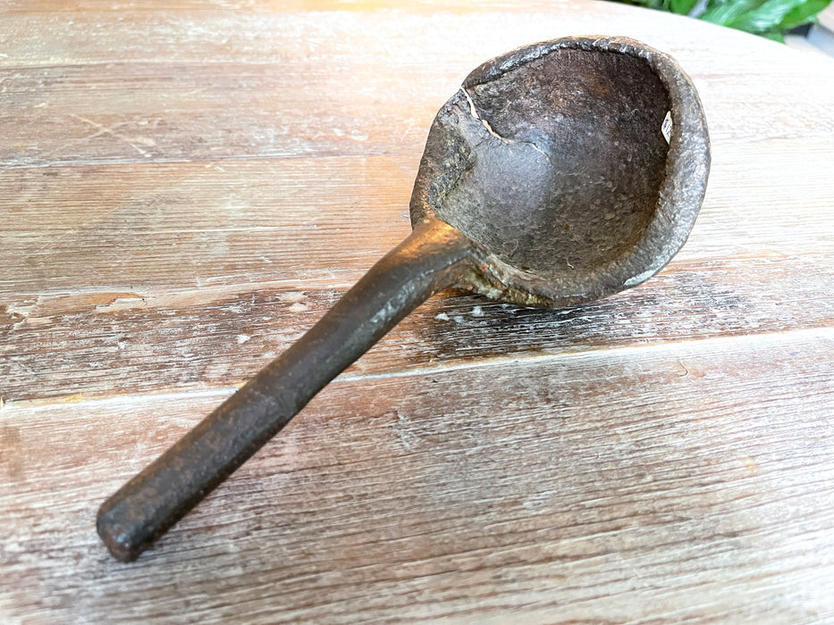 Antique iron casting spoon.